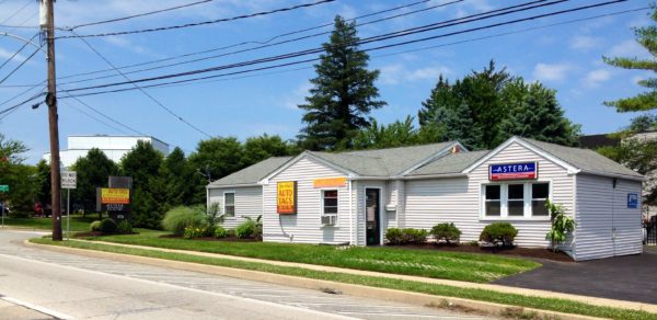 A white house sitting on the side of a road.