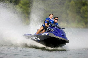 Two people on a jet ski in the water.